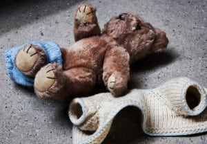 Stripped teddy on concrete floor