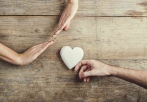 Man offering a heart to a woman.