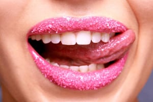 Cropped shot of a woman licking her lips covered in sugar